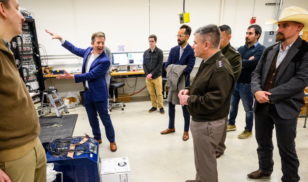 Mark Eriksson explains UW–Madison quantum computing equipment to Lt. Gen. Joe Hartman of U.S. Cyber Command.